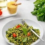Blésotto au pesto servi dans une assiette avec une fourchette